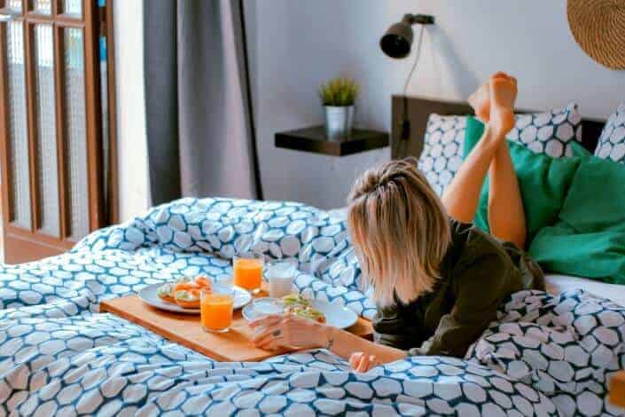 woman having breakfast in bed