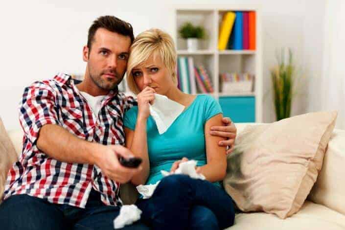 woman crying and watching a movie with partner