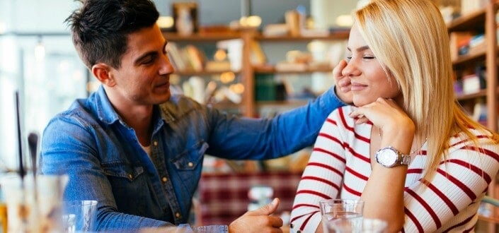 man touching a woman's cheek