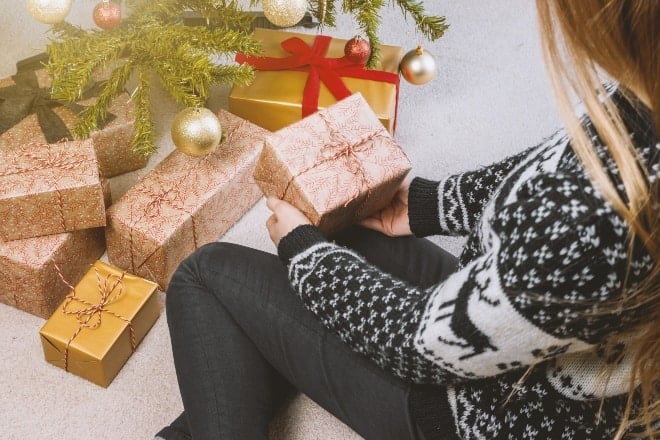 Woman in Sweatshirt and Jeans Holding Gift - christmas gift ideas for wife