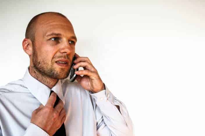 Tense man talking on the phone