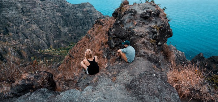 Couple sitting on a cliff