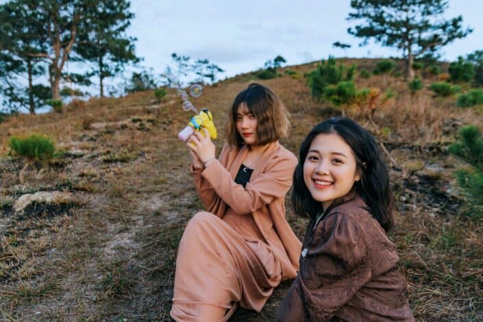 photo-of-women-sitting-on-grass-