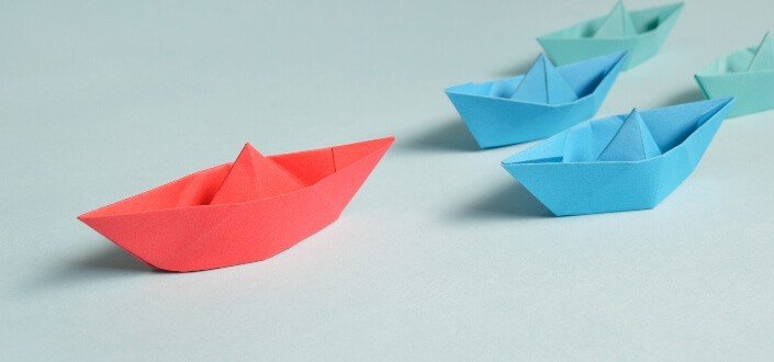 different colors of paper boats