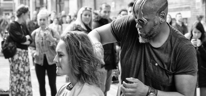 Man giving a haircut outdoors