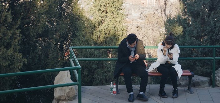 Man and Woman Sitting on an Outdoor Bench
