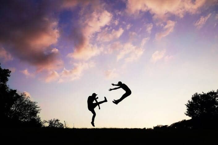 2 people doing karate during sunset