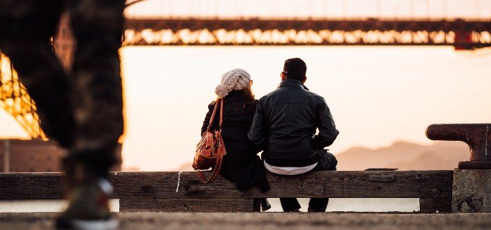 man sitting beside woman also sitting outside