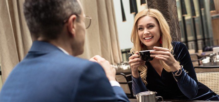 Beautiful adult couple on date at cafe