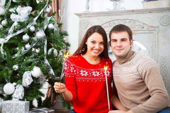 happy couple beside a christmas tree