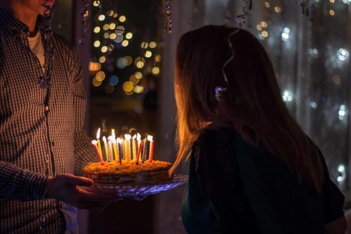 Woman blowing her birthday candles