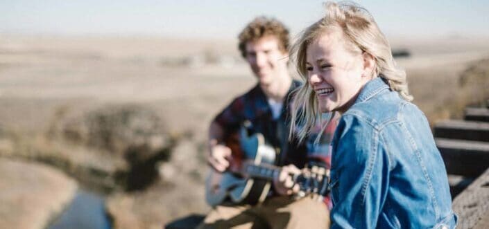 Man playing a guitar to his girl