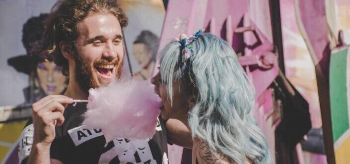 man teasing girl eating cotton candy