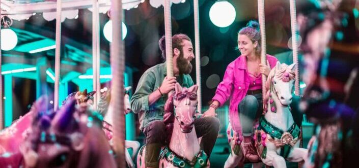 Couple riding a carousel.