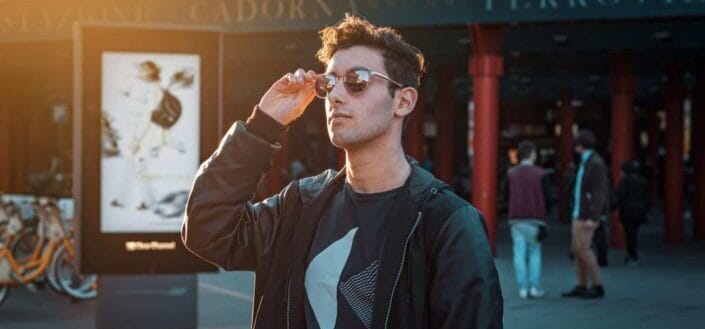 Man in black zip-up jacket wearing sunglasses