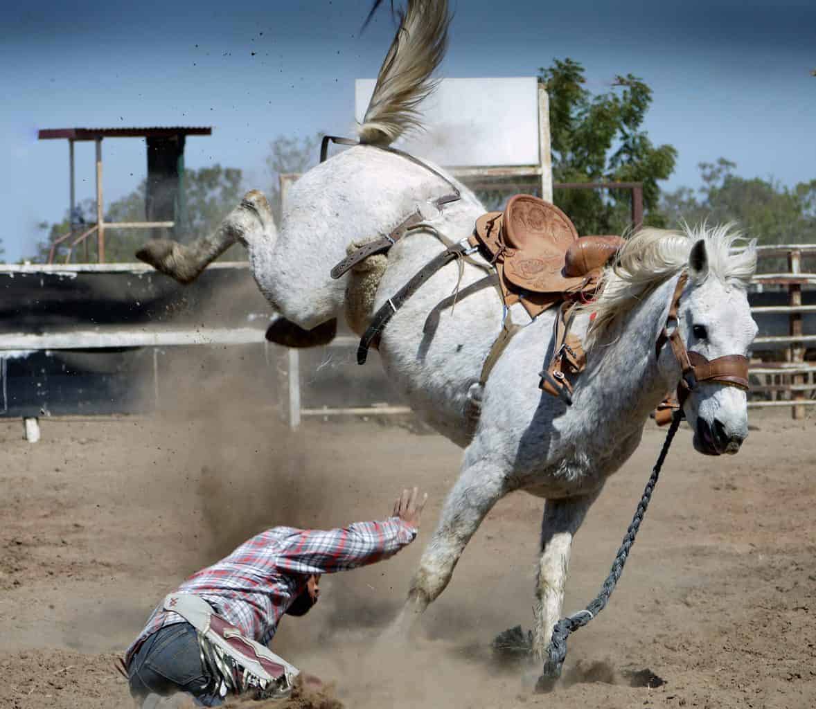 A horseback rider falling from his horse