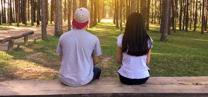 Two people looking forward at the forest