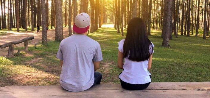 Two people looking forward at the forest