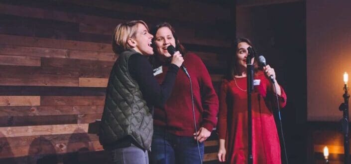 Three women singing at karaoke