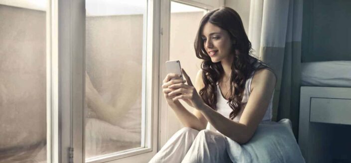 woman sitting near window