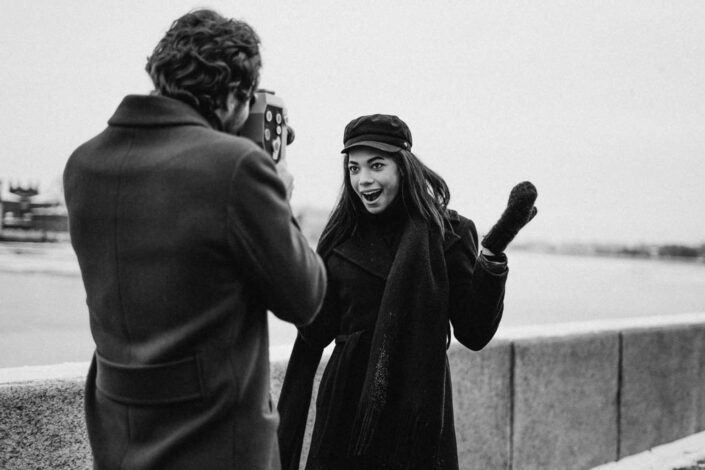 A woman posing for a photo that the man is taking