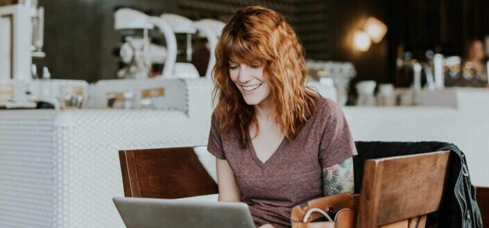 Woman smiling while using laptop