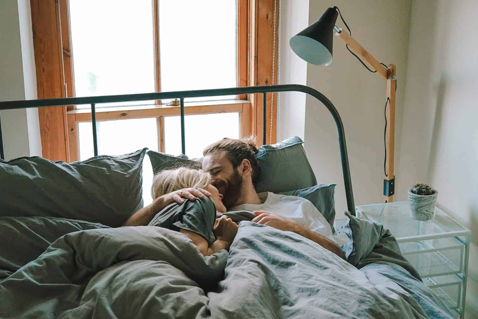 couple cuddling in bed