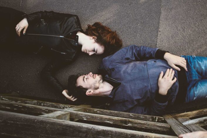 Couple lying on the ground romantically.
