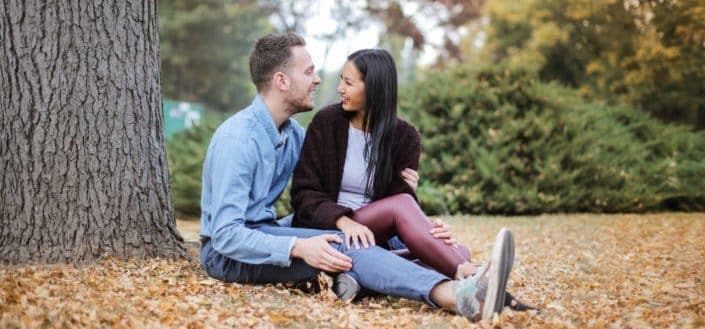 Couple sitting underneath an old tree