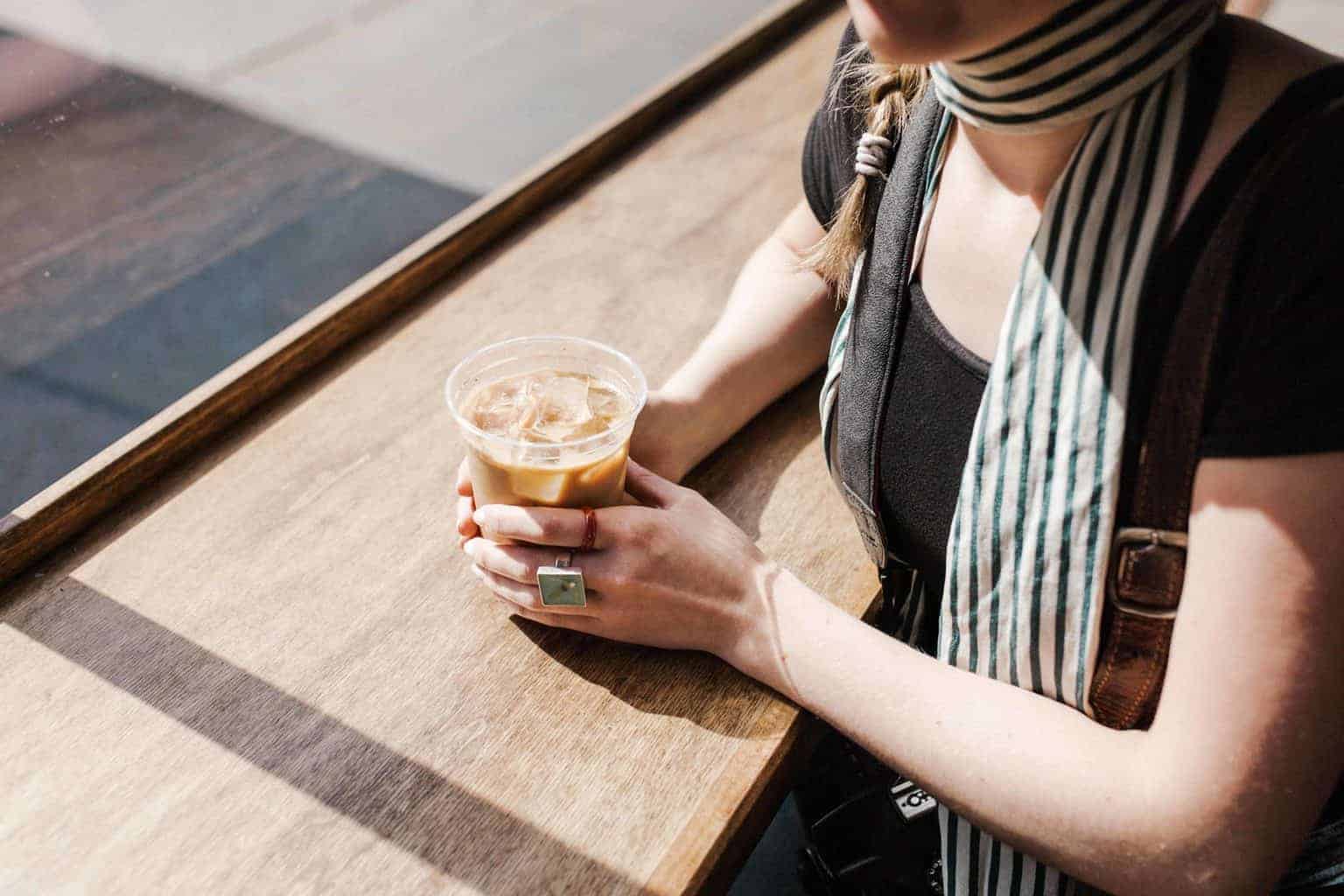 Girl holding a cup of iced coffee 