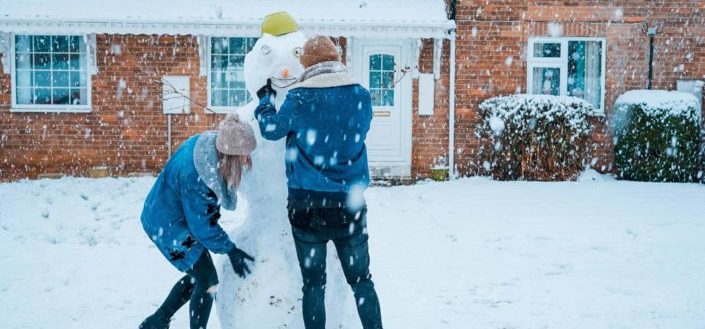 Couple building a snowman