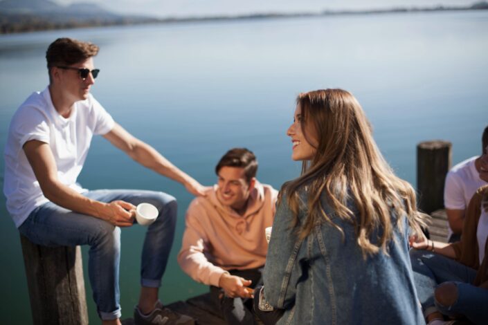 Friends sitting on a platform beneath a lake.