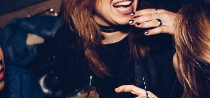 women happily drinking at the party