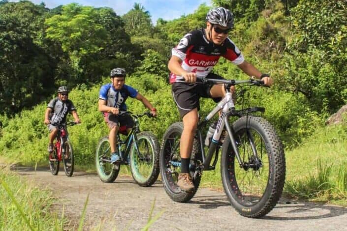 three men riding on bicycles 