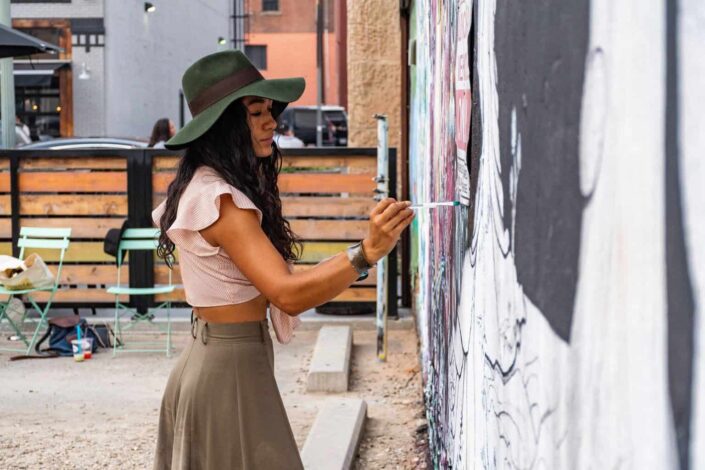 woman painting on wall