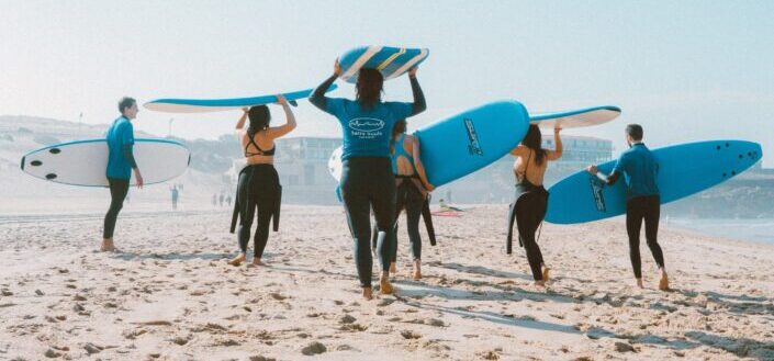 group-of-people-carrying-surfboards-pexels