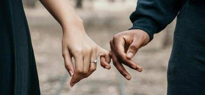 Man and woman doing a finger promise.