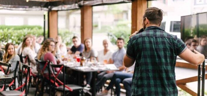 Man talking in front of people