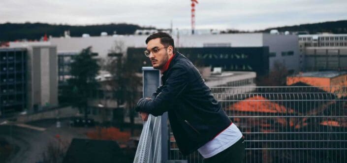 Man leaning on the railing and thinking.