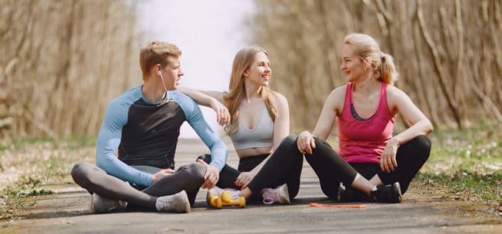 Friends sitting on the ground after a jog