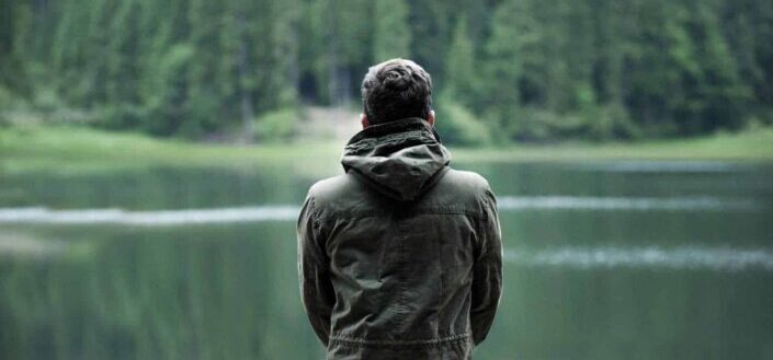 Man Looking at River in the Forest