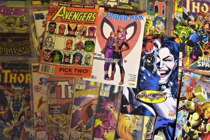 Different marvel comic posters on the wall
