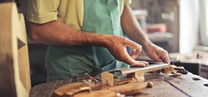 repairman fixing a violin