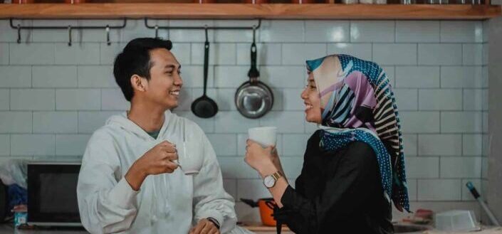 man and woman drinking tea in kitchen