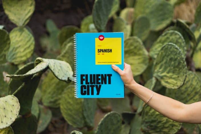 Person holding a Spanish language book