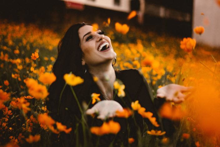 Woman having fun in field of flowers