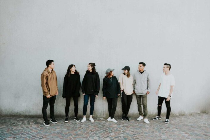 Group of friends standing against a wall