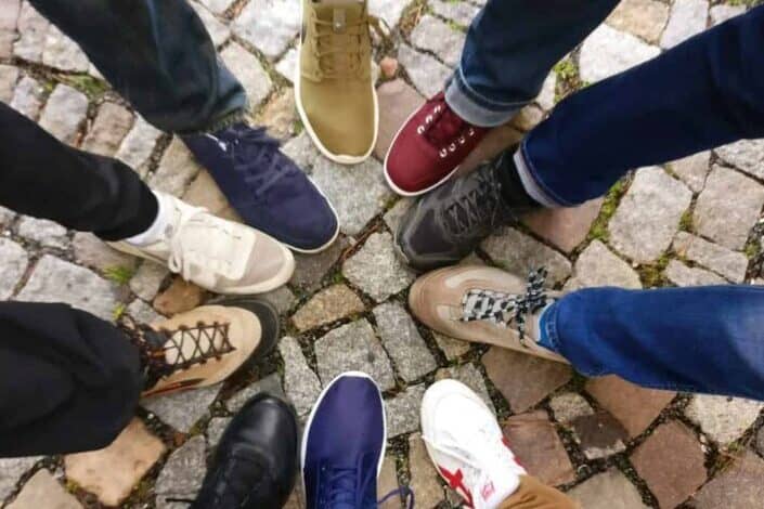 People wearing sneakers gathered in circle