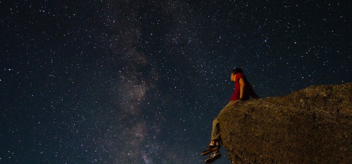 man sitting while looking at the stars