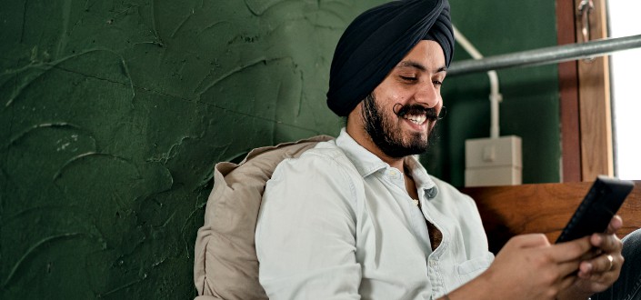 man smiling while sending message